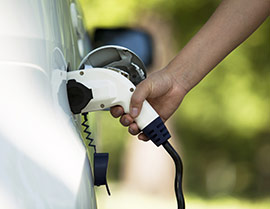 An electric car being plugged in.
